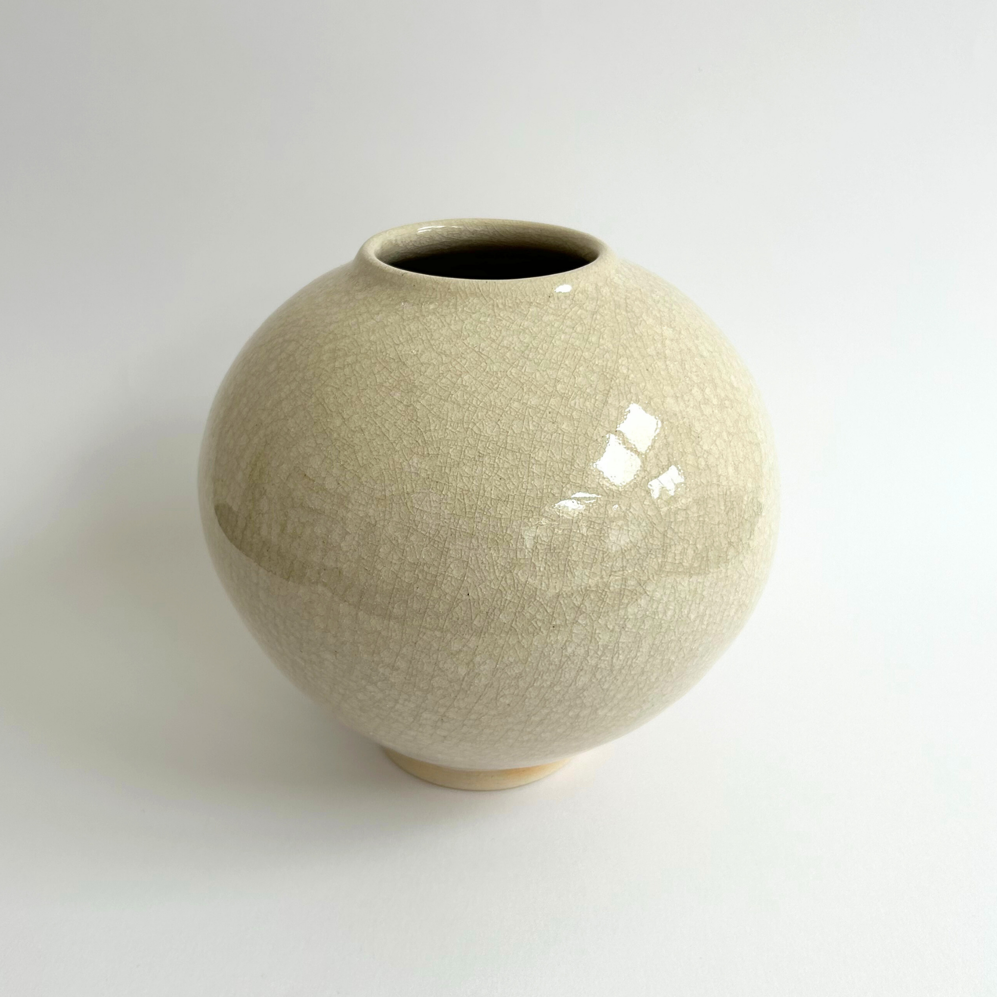 Beige ceramic vase on a white background